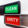 A close-up of a dishwasher magnet sign showing the word CLEAN in green and DIRTY in red.