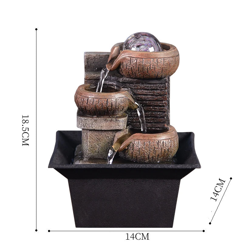 A brown tabletop water fountain featuring stacked ceramic tiers and a glass orb.