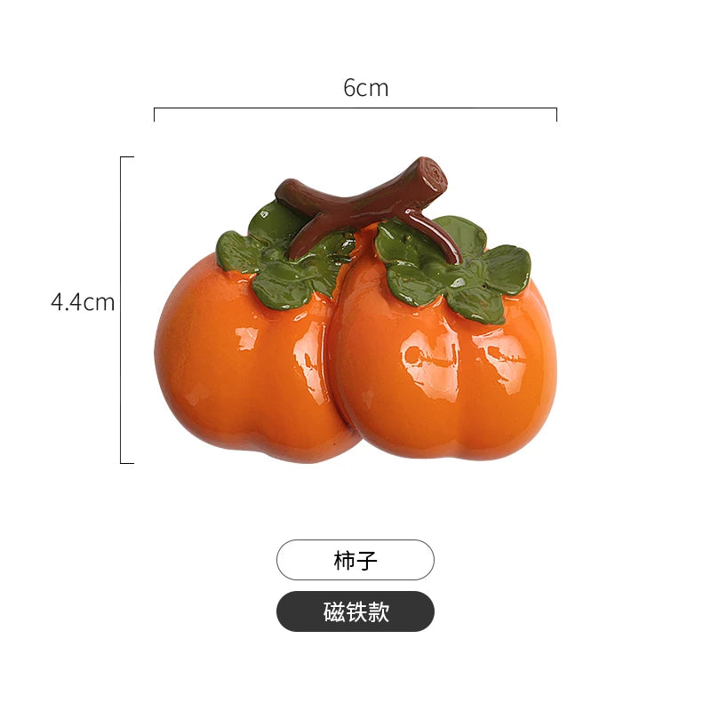 A set of realistic orange fruit and vegetable fridge magnets, including a pumpkin and a squash with green leaves.