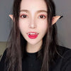 A close-up portrait of a woman wearing realistic latex elf ears for cosplay.