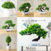 Artificial bonsai tree in a white pot displayed on a wooden desk with various size options.
