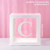 A white transparent box with the letter C inside, used for birthday and baby shower decorations.