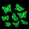 A set of green glow-in-the-dark butterfly and moth wall stickers on a black background.
