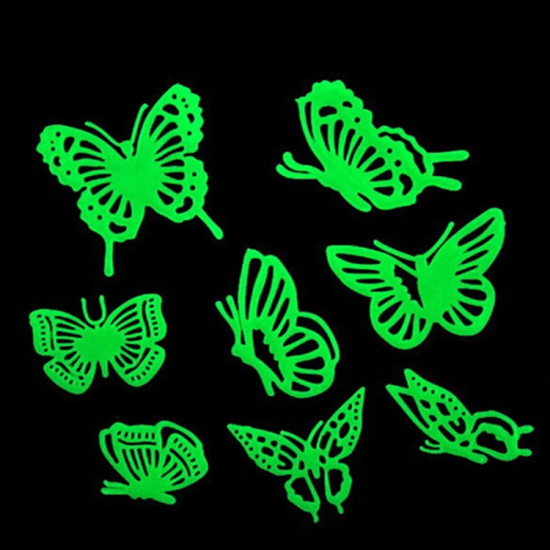 A set of green glow-in-the-dark butterfly and moth wall stickers on a black background.