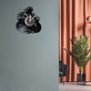 A black motorcycle rider vinyl record wall clock mounted on a gray wall.