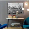 Black and white canvas wall art depicting a cityscape skyline with people on a train.