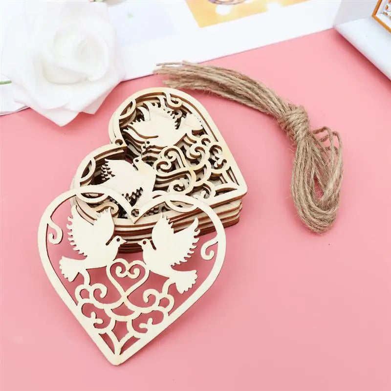 A set of ten wooden heart-shaped hanging ornaments with intricate bird designs on a pink background.