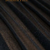 Close-up texture of dark sheer chiffon fabric draped in vertical folds.