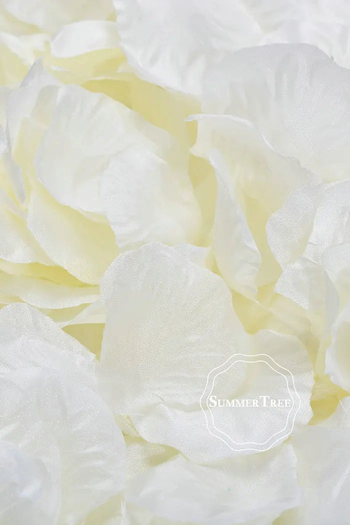 A close-up of soft, creamy white silk rose petals arranged in a loose pile.