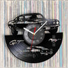 A wall clock featuring a black silhouette of a sports car and a vinyl record design.