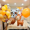 A set of woodland animal foil balloons including a fox, a deer, and a bear, arranged for a party decoration.