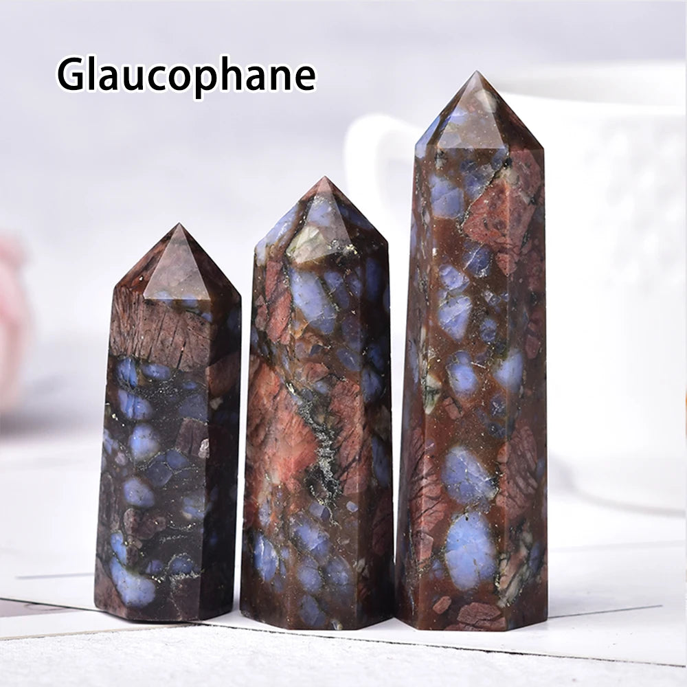 Three dark brown and blue translucent crystal point prisms standing upright on a white surface.