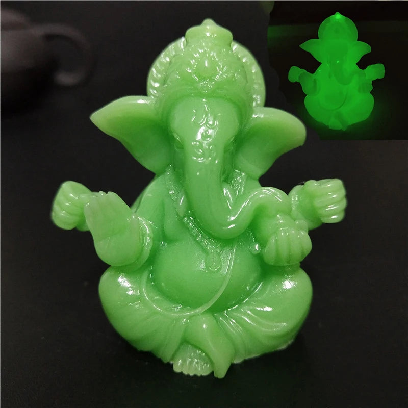 Handcrafted Buddha statue in light green color shown against a dark background.