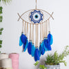 Handmade boho evil eye dream catcher wall decor featuring a woven circle and blue feathers