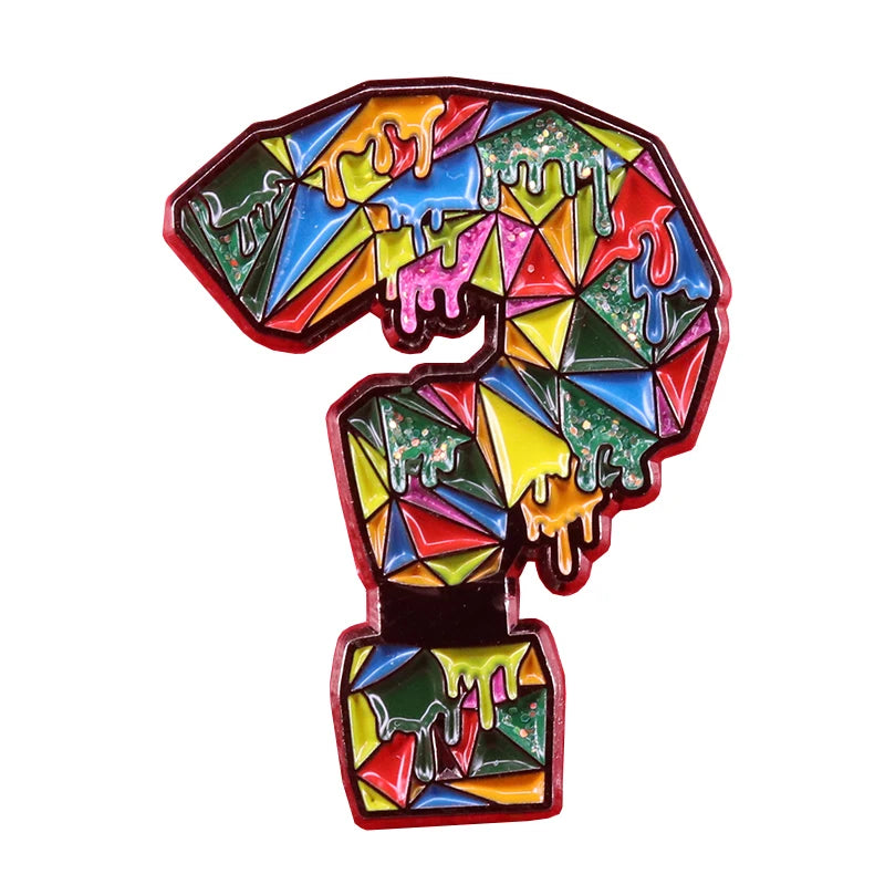 A colorful puzzle ribbon brooch pin featuring rainbow colors and dripping paint effects.