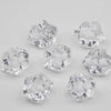 A collection of clear acrylic crystal decorations shaped like various geometric solids for parties