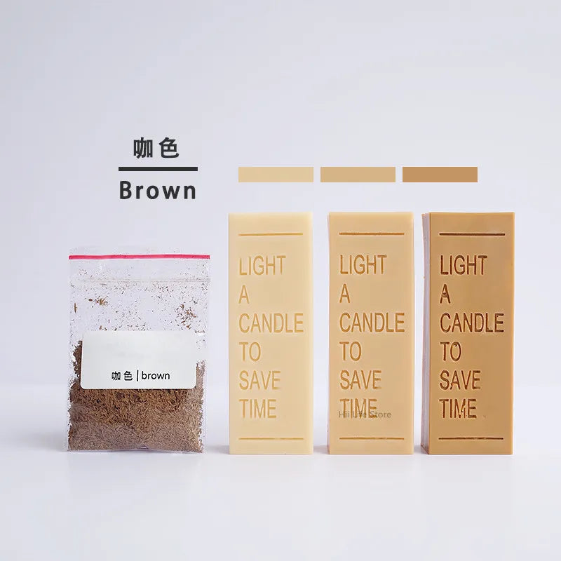 Three bars of brown candle dye colorant next to a glass jar labeled brown.