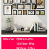 A set of black wooden photo frames with various designs displayed on a white wall.