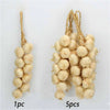 A bundle of dried, light beige artificial fruits and vegetables used for decoration or photography.