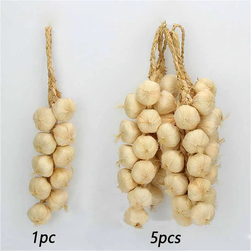 A bundle of dried, light beige artificial fruits and vegetables used for decoration or photography.