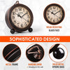 A vintage metal battery alarm clock with a glass face and solid metal sphere base shown in detail.