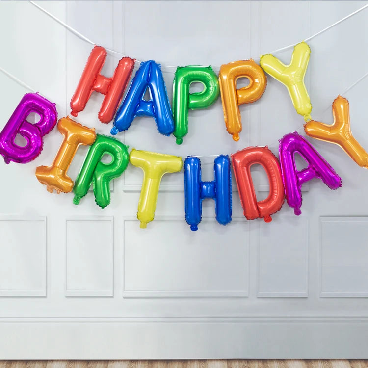 A garland of 13 foil letter balloons spelling out HAPPY BIRTHDAY in various bright colors.