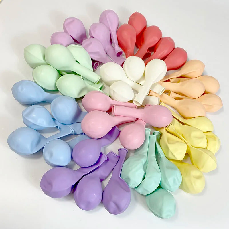 A collection of pastel candy balloons in various shades including pink, purple, green, and yellow.