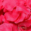 A close-up of vibrant pink silk rose petals used for weddings and events.