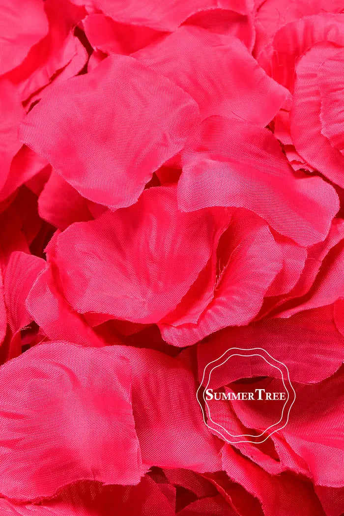 A close-up of vibrant pink silk rose petals used for weddings and events.