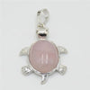 Silver pendant necklace featuring a natural pink quartz stone shaped like a stylized animal.
