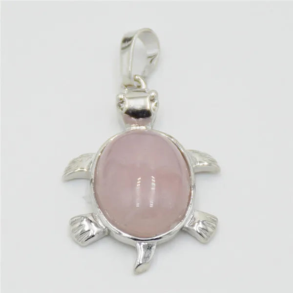 Silver pendant necklace featuring a natural pink quartz stone shaped like a stylized animal.