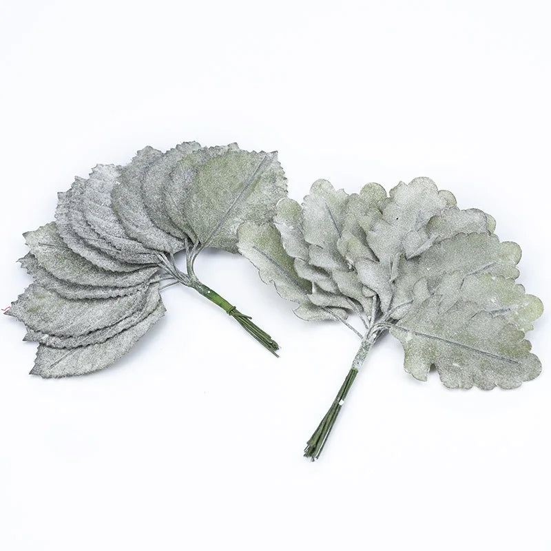 A set of twelve silk leaf artificial plant stems used for vases.