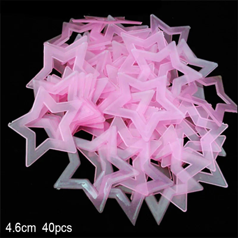 A pile of pink glow-in-the-dark star and moon wall stickers