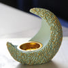 A handcrafted antique crescent incense burner with textured pale green resin and gold detailing.