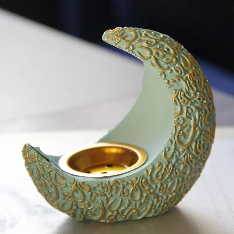 A handcrafted antique crescent incense burner with textured pale green resin and gold detailing.