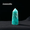 A clear, hexagonal Amazonite crystal point prism tower resting on a dark surface.