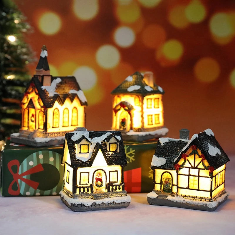 A set of three festive Christmas house night lights with warm LED glow illuminating miniature houses against a blurred bokeh 
