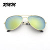 Gold-framed pilot sunglasses with mirrored green lenses shown against a white background.
