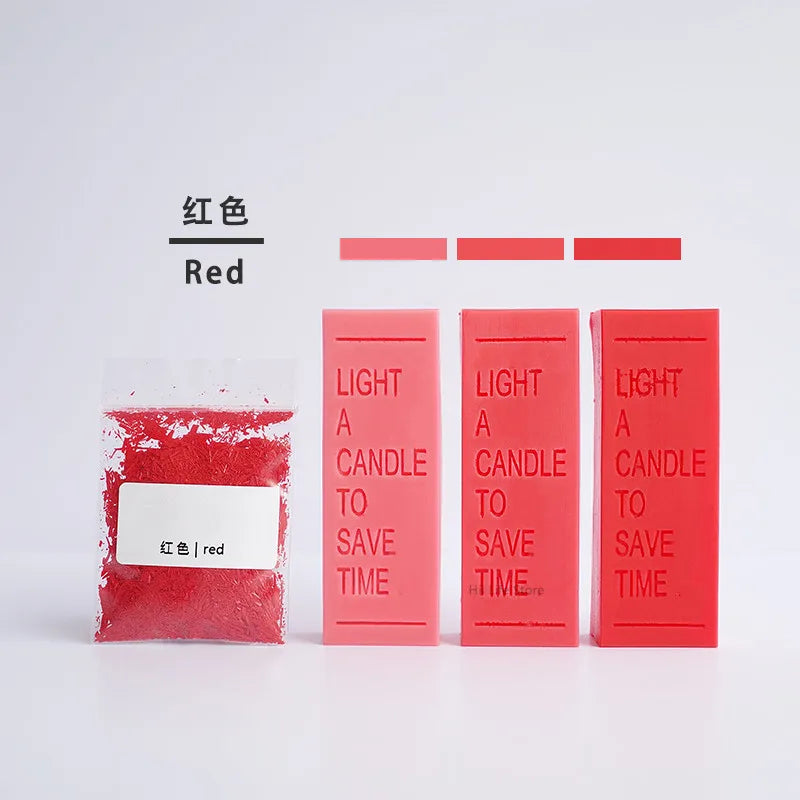 A collection of red candle dye colorants in various liquid and solid forms, labeled for use in DIY wax projects.