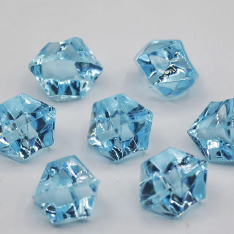 A collection of light blue acrylic crystal decorations shaped like pyramids and facets.