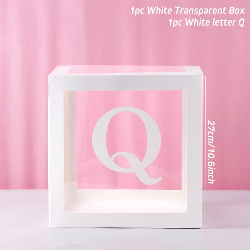 A white transparent box with a letter Q inside, used for birthday and baby shower decorations.