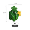 A set of three realistic green fruit and vegetable fridge magnets, including a leaf and a yellow flower.