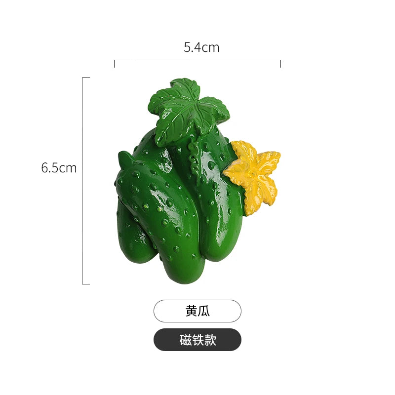 A set of three realistic green fruit and vegetable fridge magnets, including a leaf and a yellow flower.
