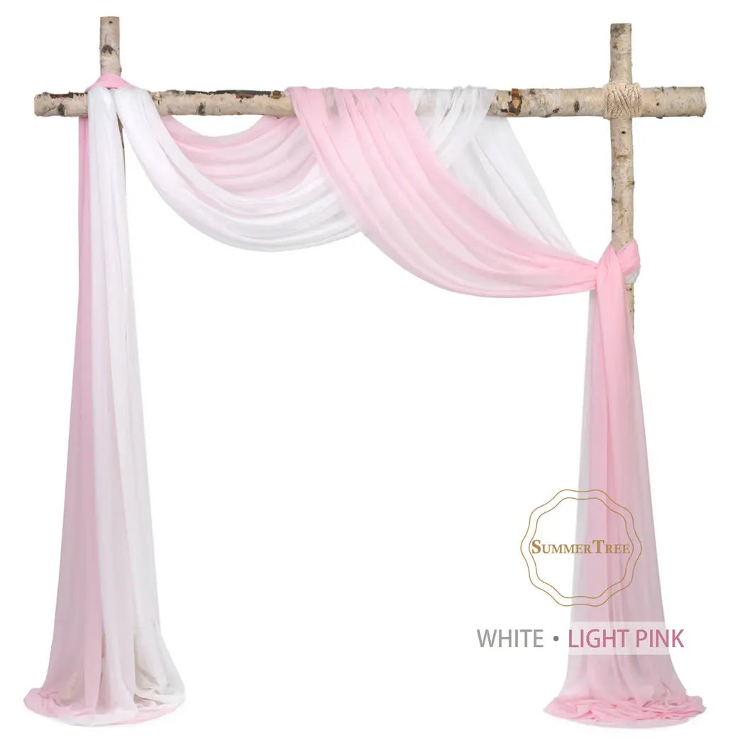 Pink and white sheer chiffon fabric drape hanging on a wooden cross for wedding or event decor