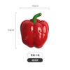 A realistic red bell pepper with a green stem, used as a fridge magnet.