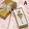 A gold-wrapped box containing a crystal rose artificial flower in a velvet insert.