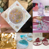 A collection of shiny gold foil flakes for resin art and jewelry making including glitter, pearls, and floral shapes.