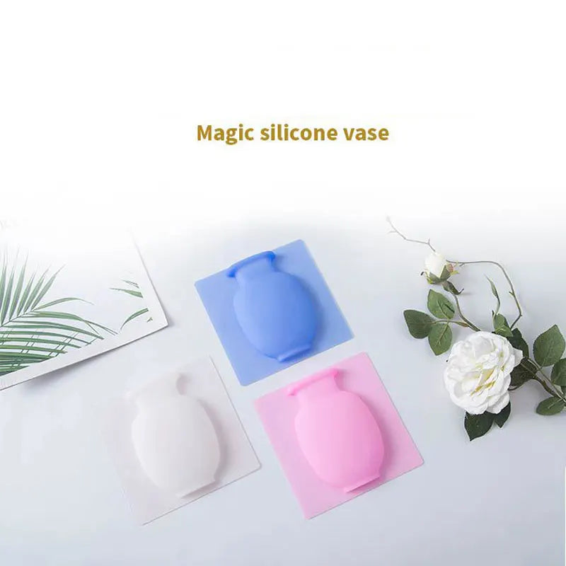 Three silicone vases in blue, pink, and white are displayed on a white background.