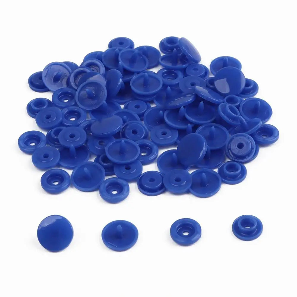 A pile of assorted blue snap buttons, measuring 12mm and 10.5mm, for crafting.