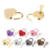 A collection of vintage heart-shaped mini padlocks and keys in gold, purple, red, pink, silver, and bronze finishes.
